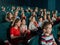 Happy children watching movie at the cinema.