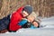 Happy children in winterwear playing in snowdrift