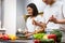 Happy Chinese Family Couple Cooking Preparing Tasty Dinner In Kitchen