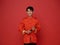Happy Chinese new year 2024. portrait Asian man happy smile wearing red traditional clothing holding red fan isolated on red