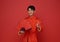 Happy Chinese new year 2024. portrait Asian man happy smile wearing red traditional clothing holding red fan and pointing