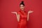 Happy Chinese new year. Asian woman wearing traditional cheongsam qipao dress with gesture of welcome chinese new year 2024