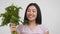 Happy Chinese Woman Holding Dill Bunch Shaking It, White Background