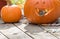 A happy chipmunk leans out of a grinning jack o lantern