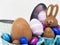 Happy chocolate Easter bunny among Easter eggs