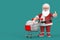 Happy Christmas and New Year Greeting Concept. Shopping cart with Discount Cubes and Cartoon Cheerful Santa Claus Granpa Giving