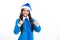 Happy Christmas and New Year. Teenage girl in a Santa hat and blue shirt. Christmas kids holiday. Emotional face