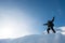 Happy climber with an ice ax in the snowy mountains