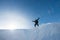 Happy climber with an ice ax in the snowy mountains