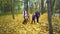 Happy close-knit family walks through the autumn Park with the dog Irish setter. The concept of a close-knit family