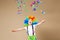 Happy clown boy with large colorful wig. Let`s party! Funny kid