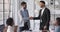 Happy company manager handshake promote praise male worker in office