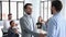 Happy confident businessman employee being promoted handshake executive manager