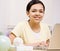 Happy, confident girl with braces using laptop