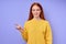 happy confident redhead woman in yellow stylish sweater demonstrating letter Z