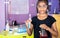 Happy confident school kid at science lab with chemical flask in hand looking camera at classroom - concept of creativity, child