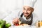 Happy Cook Man Plating Salmon Steak In Restaurant Kitchen