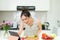 Happy cooking. Young asian woman cutting vegetables for salad in