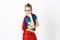 Happy and cool blond supergirl with glasses and red robe und blue shirt is posing in the studio