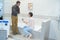 Happy couple adults choosing bathroom faucets in plumbing store