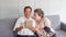 Happy couple asian senior retired using mobile tablet application technology for social network among friends community via