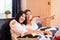 Happy couple asian woman watching TV feeling having fun .together at home
