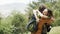 A happy couple backpackers hiking by forest, excited about view