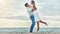 Happy couple at beach lift and hug to celebrate love on romantic sunset tropical ocean water Bali luxury vacation travel