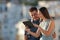 Happy couple browsing tablet content outside in a town