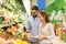 Happy couple buying avocado at grocery store