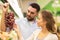 Happy couple buying grapes at grocery store