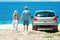 A happy couple cars by the sea in nature weekend travel