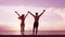 Happy couple cheering on beach enjoying sunset on summer travel vacation holiday