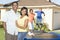 Happy Couple With Children Playing On Trampoline