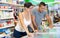 Happy couple choosing frozen convenience food in supermarket