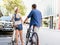 Happy couple in city with bike