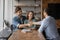 Happy couple clients shake hand with consultant at meeting