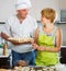 Happy couple cooking russian dumplings (pelmeni)