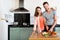 Happy Couple Cutting Vegetables At Kitchen Counter