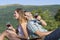 Happy couple drinking wine on a hiking trip