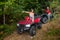 Happy couple driving four-wheelers ATV