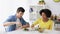 Happy couple eating vegetable salad at home