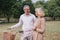 Happy couple elderly relaxing at park walking with bike and talking together in morning time. The concept of good health and relax