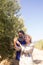 Happy couple examining olive oil in farm