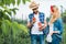 happy couple of farmers holding ripe tomatoes in field