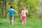 Happy Couple Farmers working with spud on spring field. Earth day. Two people gardening in the backyard garden.