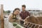 Happy couple feeding cow in a farm