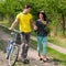 Happy couple with flowers & bicycle walking