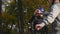 Happy couple goes on a mountain asphalt road in the woods on bikes with helmets giving each other a high five