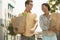 Happy Couple With Groceries Walking Outdoors